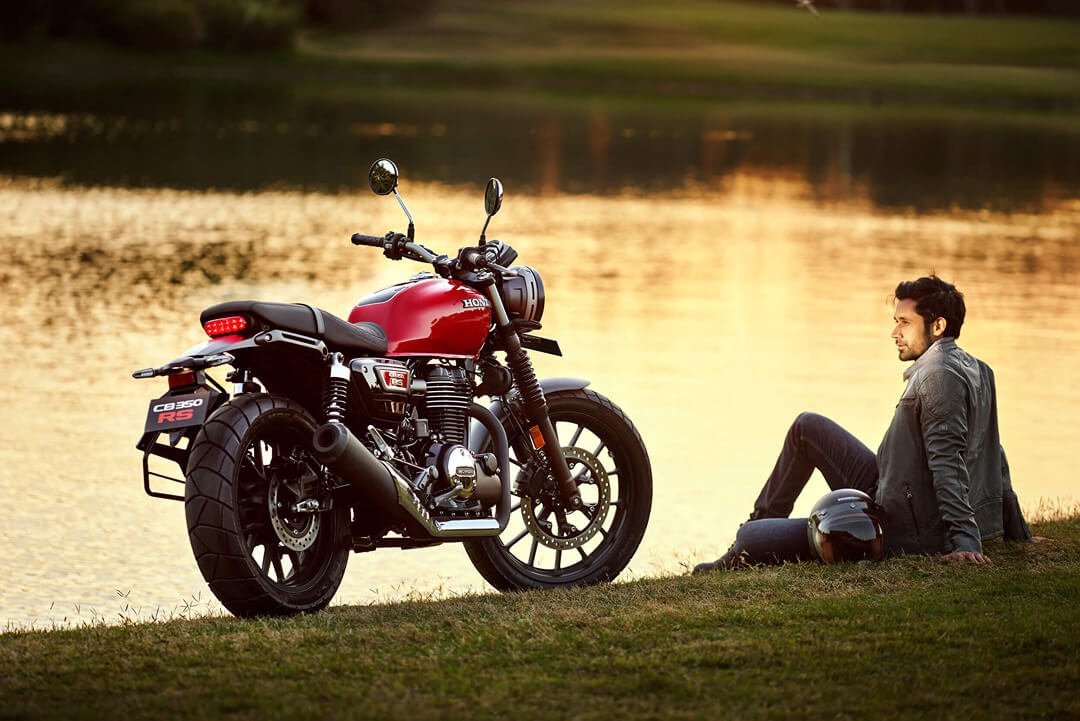 Rider relaxing beside the CB350RS at sunset